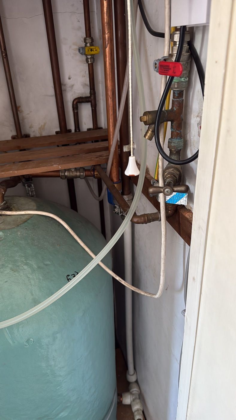 Copper pipework and gas valves above a hot water cylinder