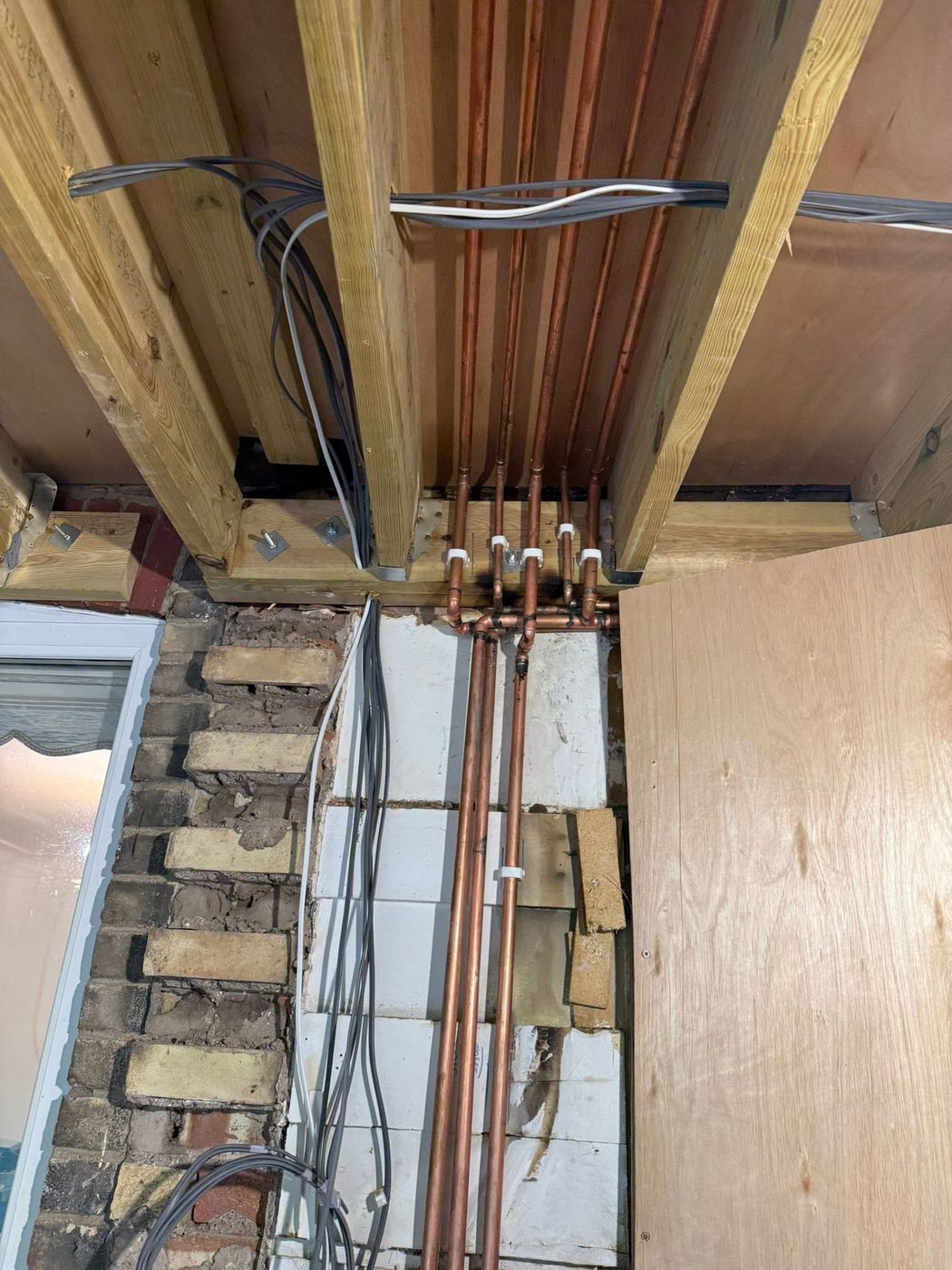 Copper pipework run between joists and clipped at even centres