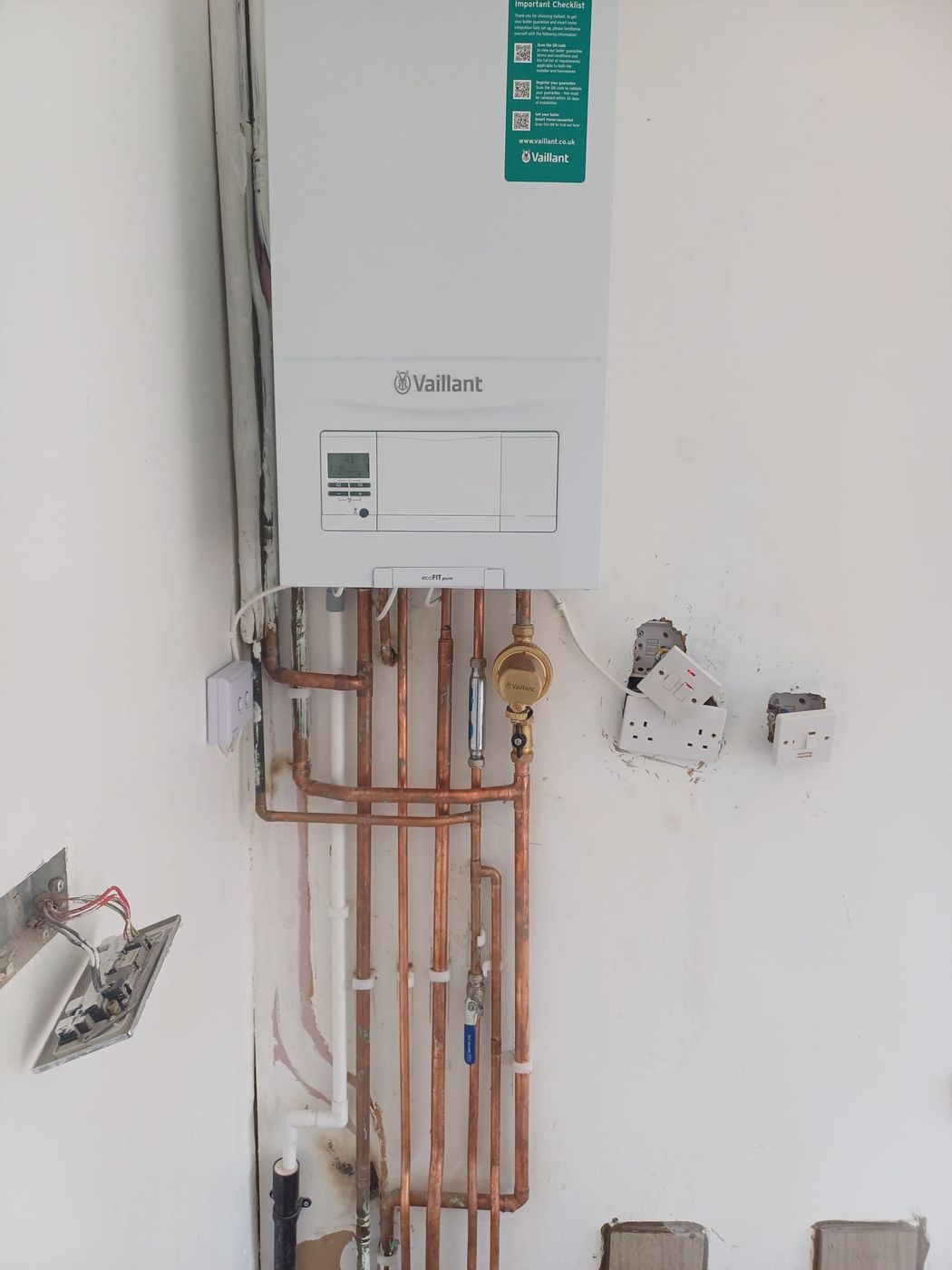 Newly installed Vaillant boiler with clipped, evenly spaced copper pipework
